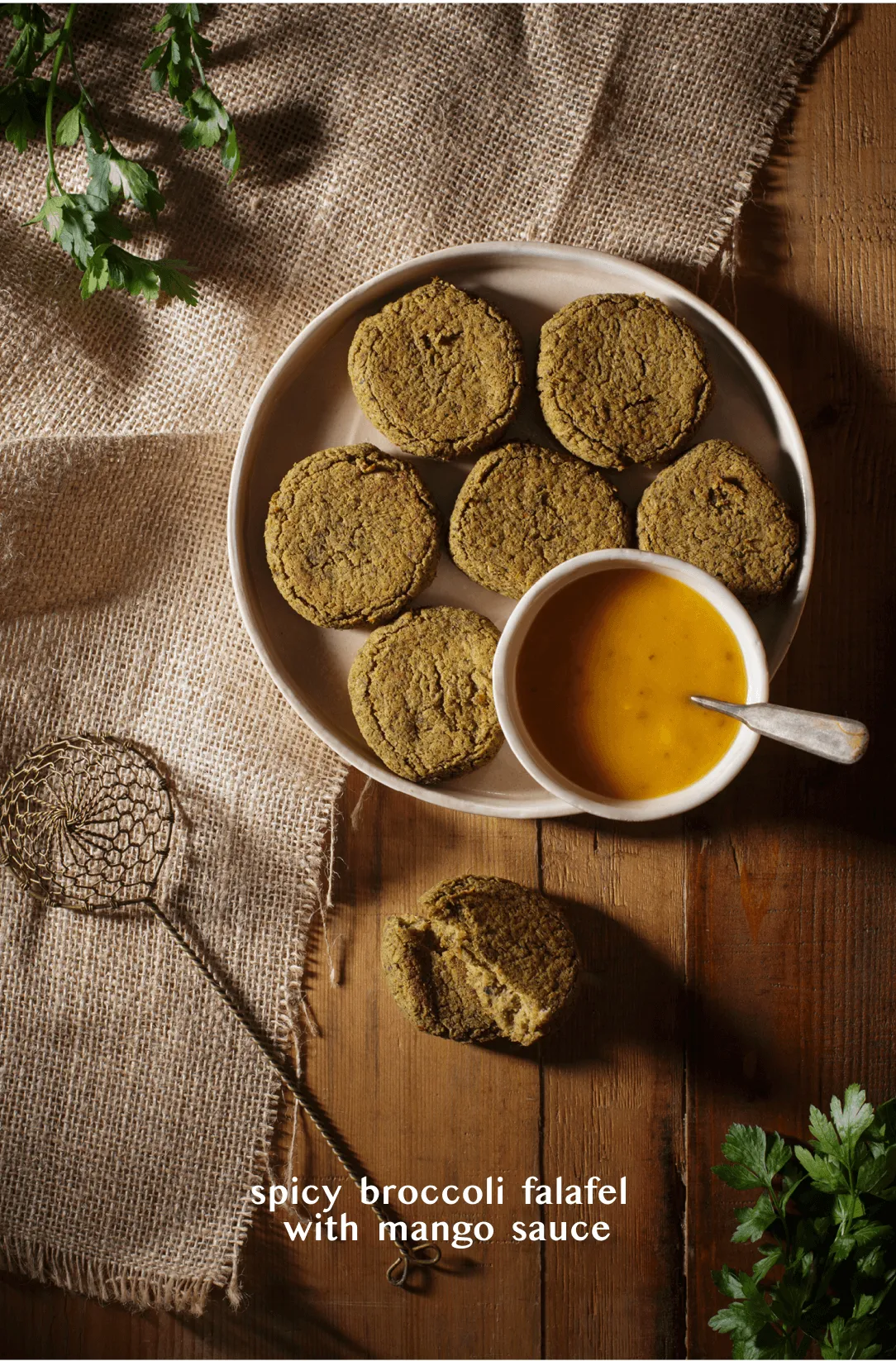 Plate of spicy broccoli falafel with a bowl of mango sauce on dark wood, titled "spicy broccoli falafel with mango sauce"