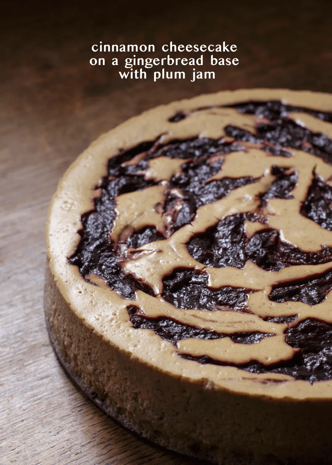 Side view of the cinnamon cheesecake on a gingerbread base, marbled with plum jam
